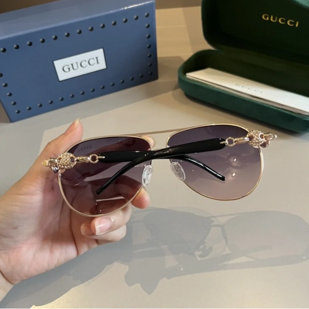 Gucci Women's Black and Gold Sunglasses